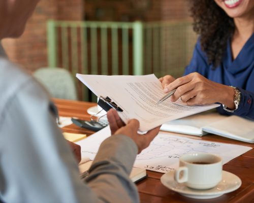 Businessman consulting with lawyer before signing contract